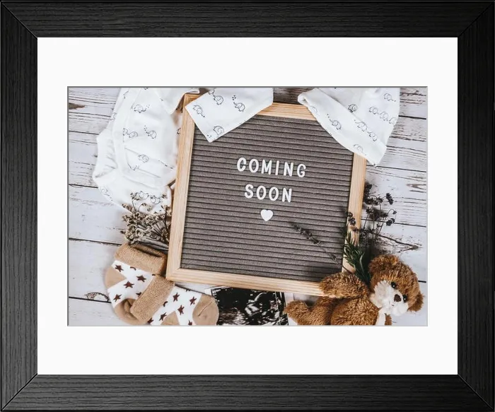Framed Print : Coming soon sign. Baby announcement sign on a rustic white background. Coming soon concept Framed Print : Coming soon sign. Baby announcement sign on a rustic white background. Coming soon concept