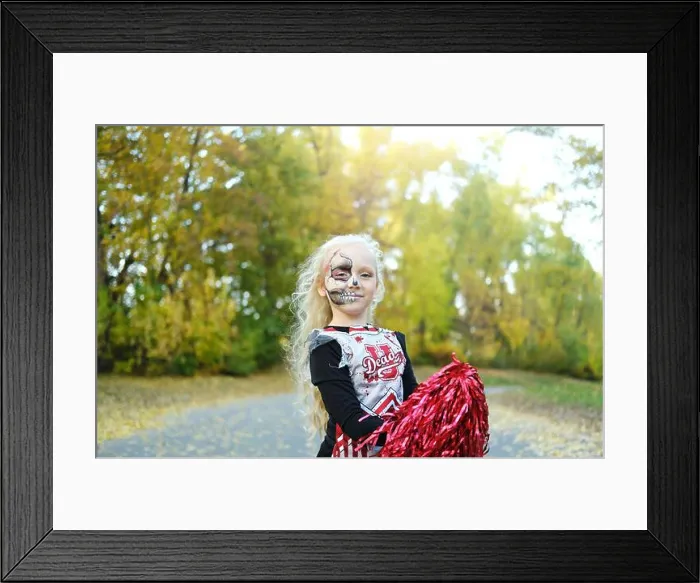 Framed Print : A girl in a cheerleader costume and half-face makeup in the form of a skeleton celebrates Halloween. Horizontal photo Framed Print : A girl in a cheerleader costume and half-face makeup in the form of a skeleton celebrates Halloween. Horizontal photo