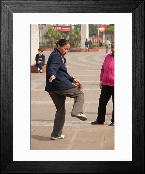 Framed Print : A Chinese woman juggling a shuttlecock, Luzhi, Guizhou Province, China