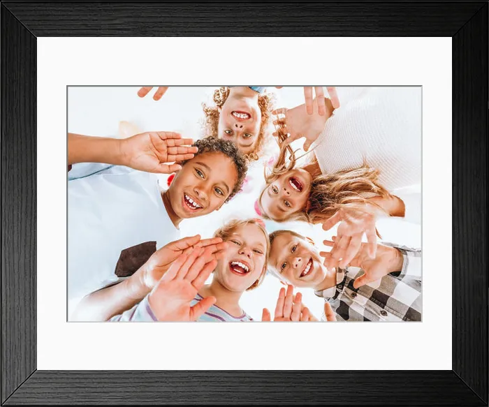 Framed Print : Group of happy children waving at the camera Framed Print : Group of happy children waving at the camera