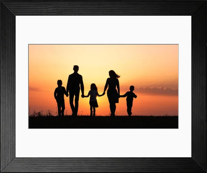 Framed Print : Silhouettes of happy family holding the hands in the meadow during sunset Framed Print : Silhouettes of happy family holding the hands in the meadow during sunset