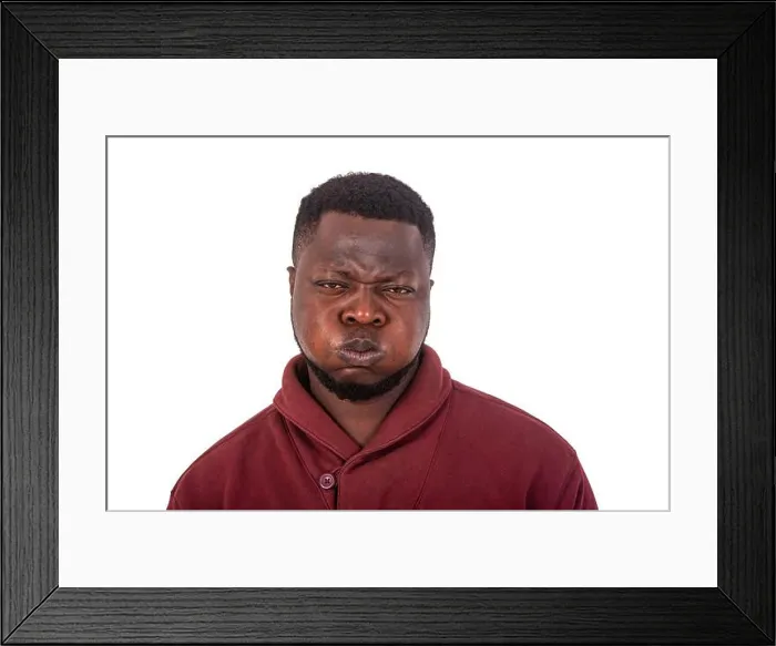 Framed Print : portrait of a handsome young man making grimace with face while puffing up his cheeks and looking at camera Framed Print : portrait of a handsome young man making grimace with face while puffing up his cheeks and looking at camera