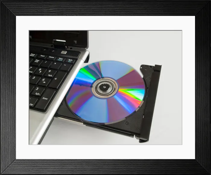 Framed Print : A rewritable CD ROM in the CD drive of a labtop computer Framed Print : A rewritable CD ROM in the CD drive of a labtop computer