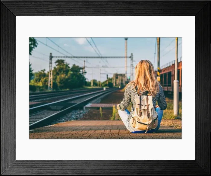 Framed Print : Backpacker woman sitting on railway station platform and waiting for train. Traveling in Europe during summer Framed Print : Backpacker woman sitting on railway station platform and waiting for train. Traveling in Europe during summer