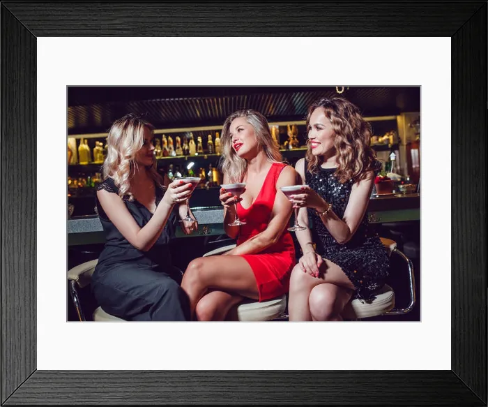 Framed Print : Beautiful women are sitting on the bar and drinking cocktails Framed Print : Beautiful women are sitting on the bar and drinking cocktails
