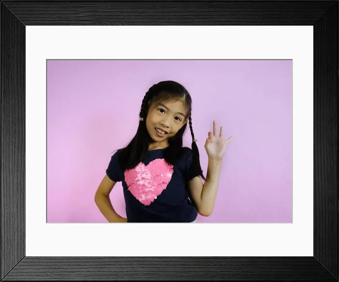 Framed Print : A half body shot of a cute young Asian girl Framed Print : A half body shot of a cute young Asian girl