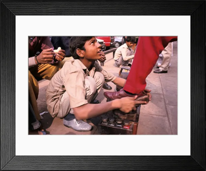Framed Print : a shoe shine boy at work in connaught place new delhi india Framed Print : a shoe shine boy at work in connaught place new delhi india