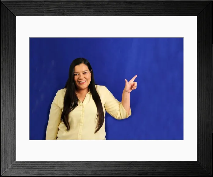 Framed Print : 40-year-old Latina woman points with the fingers of her hand to something that she likes Framed Print : 40-year-old Latina woman points with the fingers of her hand to something that she likes