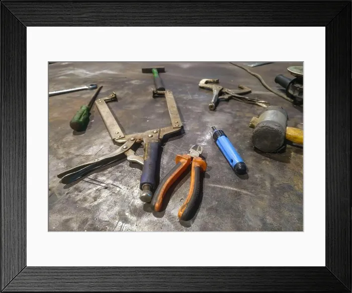Framed Print : the workplace of a locksmith welder with different tools at the factory Framed Print : the workplace of a locksmith welder with different tools at the factory
