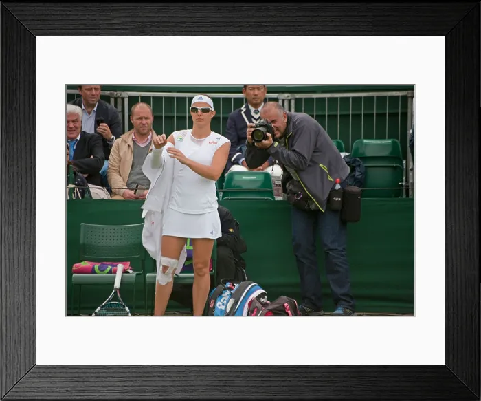 Framed Print : Female Tennis player wearing sunglasses at Wimbledon as photographer takes he photograph from behind as she takes off Framed Print : Female Tennis player wearing sunglasses at Wimbledon as photographer takes he photograph from behind as she takes off