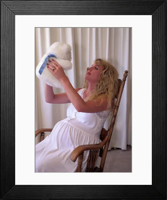 Framed Print : big pregnant woman model in white dress talking to a white teddy bear imagining that it is her baby that is soon to be