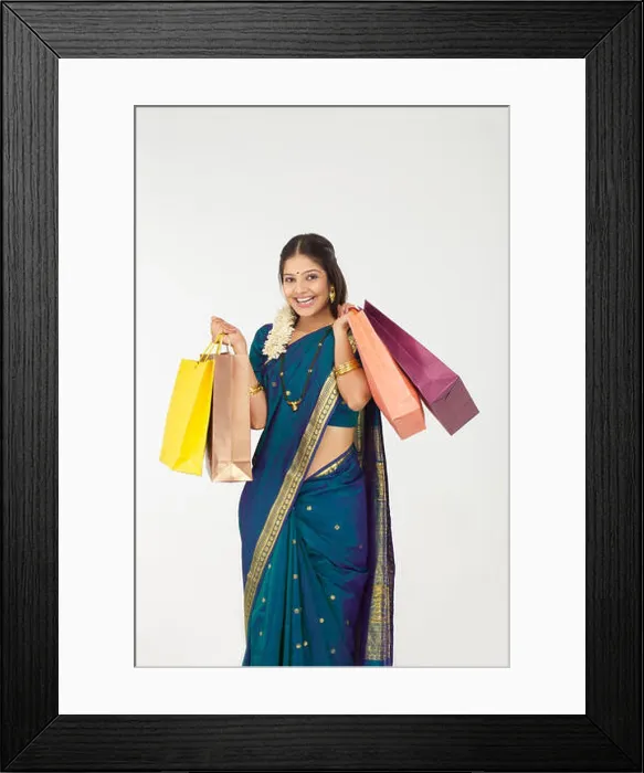 Framed Print : South Indian woman carrying shopping bags and smiling