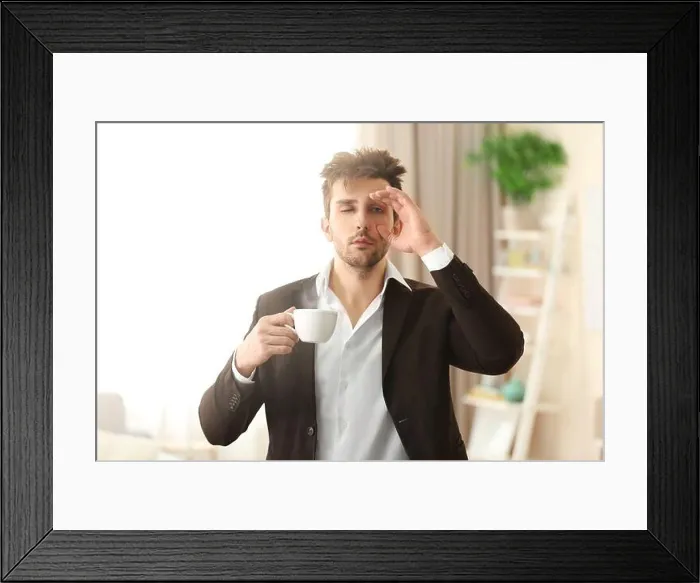 Framed Print : Sleepy guy holding a cup of coffee Framed Print : Sleepy guy holding a cup of coffee
