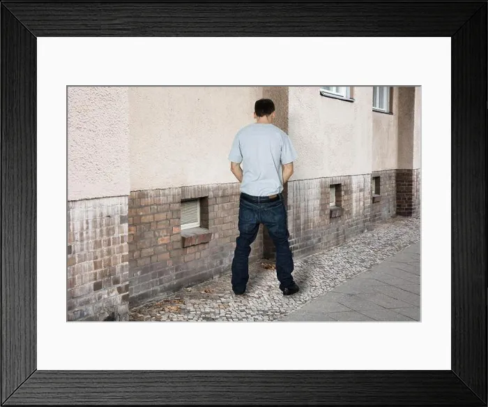 Framed Print : Man Peeing On The Wall Of A Building Framed Print : Man Peeing On The Wall Of A Building