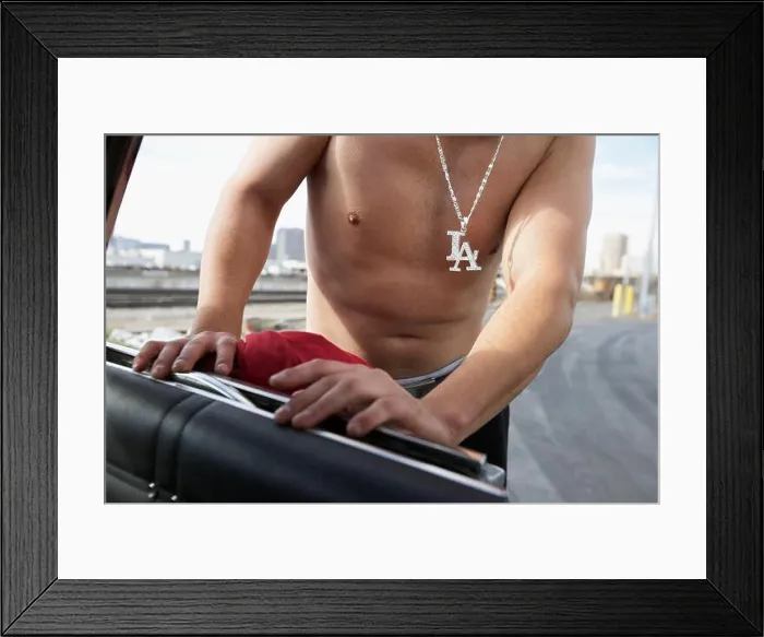 Framed Print : Mid section of shirtless man wearing LA necklace Framed Print : Mid section of shirtless man wearing LA necklace