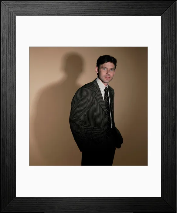 Framed Print : Man wearing suit with his hands in his pockets Framed Print : Man wearing suit with his hands in his pockets