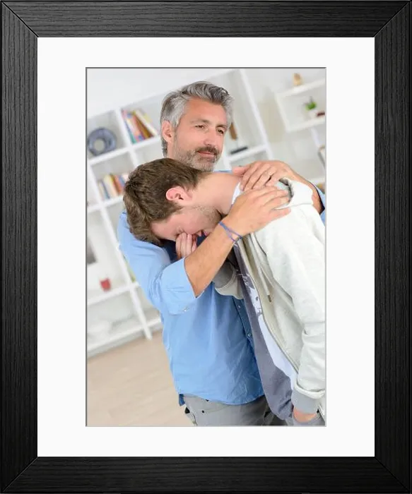 Framed Print : a father hugging young man crying Framed Print : a father hugging young man crying