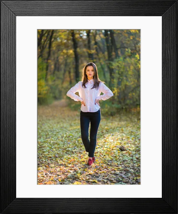 Framed Print : Posing on footpath in forest. A serious looking girls is posing in a pink shirt Framed Print : Posing on footpath in forest. A serious looking girls is posing in a pink shirt