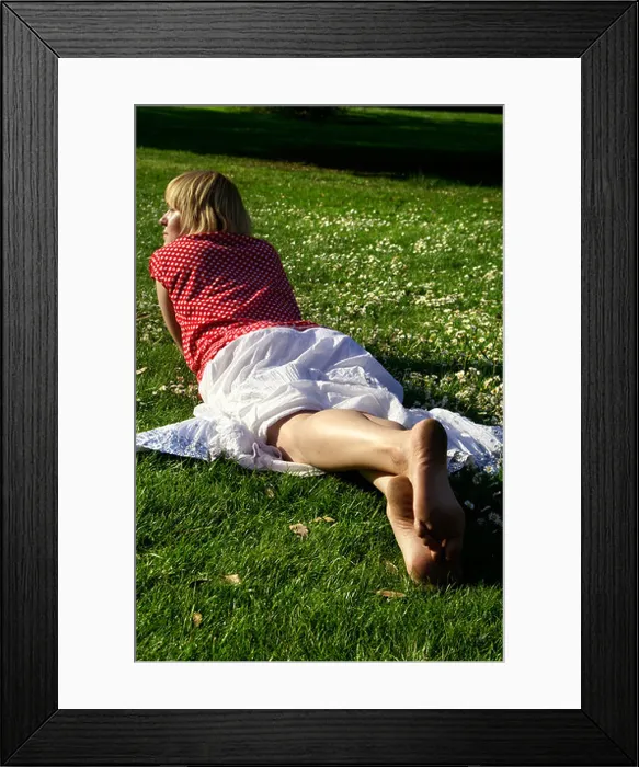 Framed Print : Blonde bare feet young woman teen girl lying down on lawn grass wearing red blouse and white long skirt back Framed Print : Blonde bare feet young woman teen girl lying down on lawn grass wearing red blouse and white long skirt back
