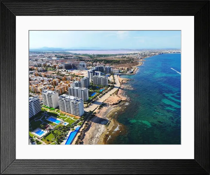 Framed Print : Aerial view of Punta Prima coastline with modern high-rise residential building. Costa Blanca, Alicante province. Spain Framed Print : Aerial view of Punta Prima coastline with modern high-rise residential building. Costa Blanca, Alicante province. Spain
