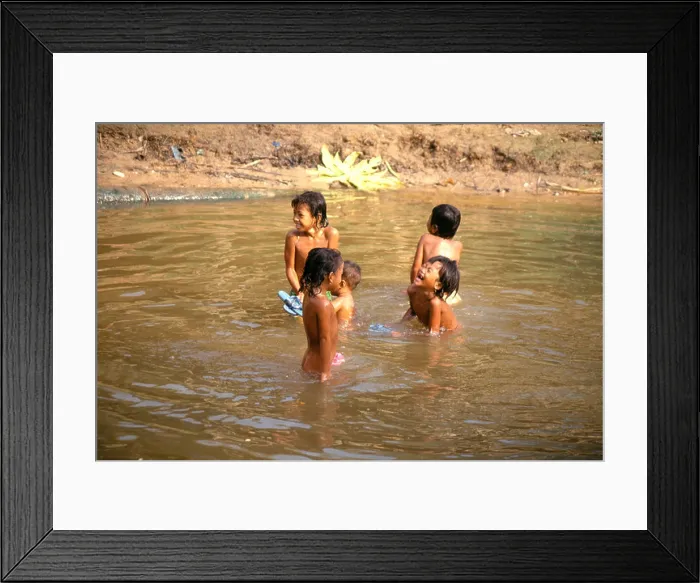 Framed Print : Cambodian children playing in the water at Angkor Wat temple.Siem Reap Framed Print : Cambodian children playing in the water at Angkor Wat temple.Siem Reap