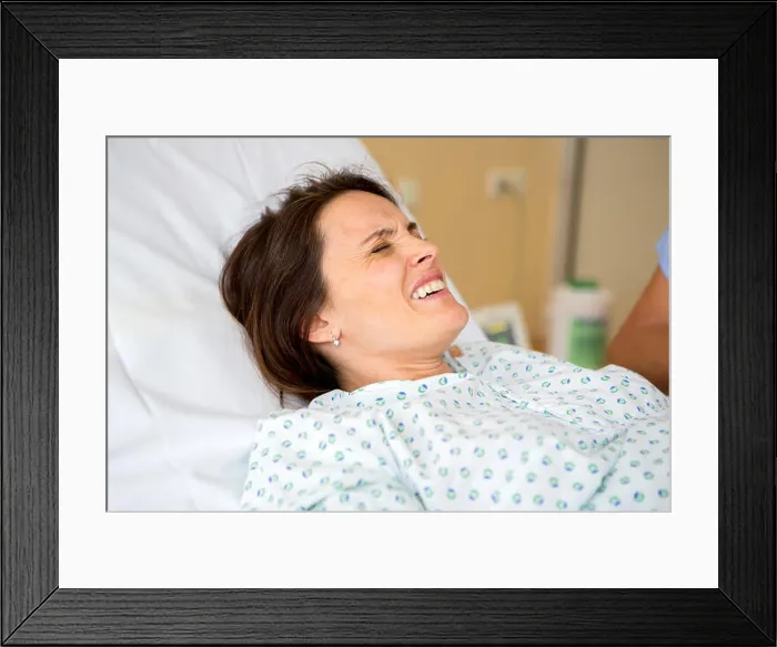 Framed Print : Pregnant woman in delivery room, having contractions Framed Print : Pregnant woman in delivery room, having contractions