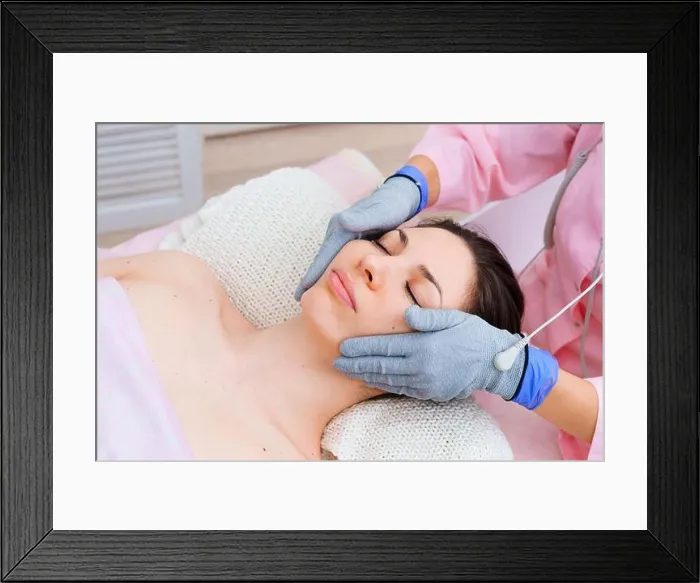 Framed Print : Micro-sensory electric microcurrent procedure bio ems for electrode stimulation of face and body with conductive gloves Framed Print : Micro-sensory electric microcurrent procedure bio ems for electrode stimulation of face and body with conductive gloves