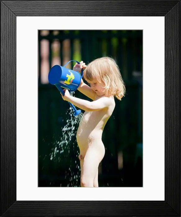 Framed Print : boy pouring water on himself from watering-can during hot summer Framed Print : boy pouring water on himself from watering-can during hot summer