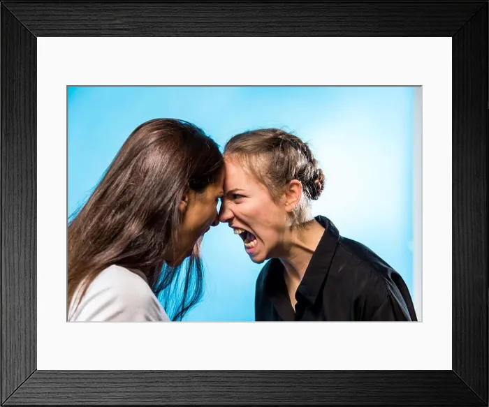 Framed Print : Two women screaming at one another looking at each other face to face. Profile Framed Print : Two women screaming at one another looking at each other face to face. Profile