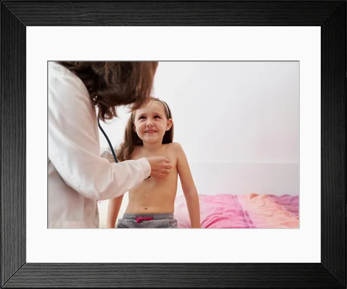 Framed Print : Pediatric doctor examine little happy girl with stethoscope. Child, care. Home doctor concept Framed Print : Pediatric doctor examine little happy girl with stethoscope. Child, care. Home doctor concept