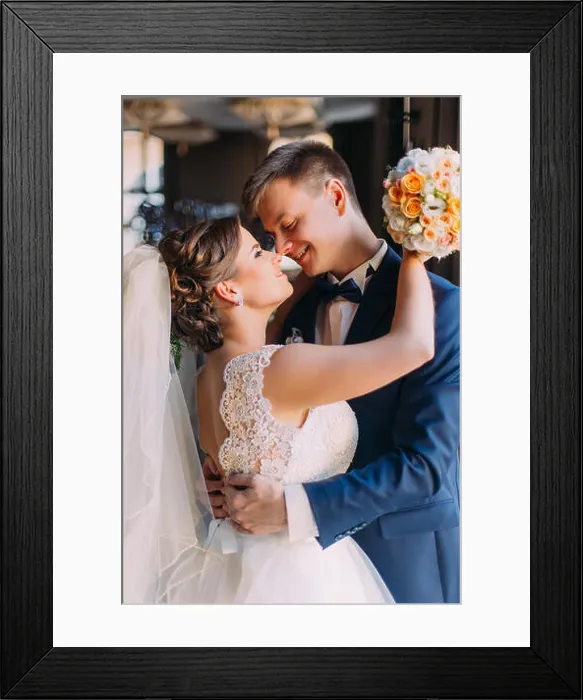Framed Print : Enloved wedding couple. Beautiful bride with bouquet and handsome groom standing indoors Framed Print : Enloved wedding couple. Beautiful bride with bouquet and handsome groom standing indoors
