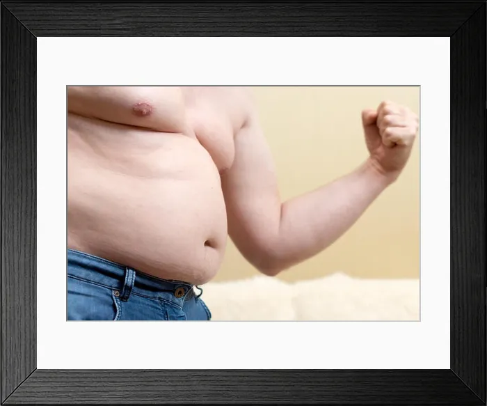 Framed Print : Fat funny man in jeans shows his biceps Framed Print : Fat funny man in jeans shows his biceps