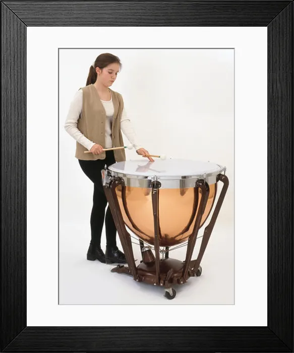Framed Print : Teenage girl playing timpani drum, close-up Framed Print : Teenage girl playing timpani drum, close-up
