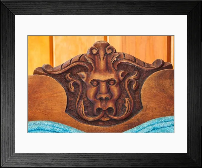 Framed Print : Close-up of carved gargoyle's head on backrest of blue velvet upholstered antique walnut wood chair in hallway Framed Print : Close-up of carved gargoyle's head on backrest of blue velvet upholstered antique walnut wood chair in hallway