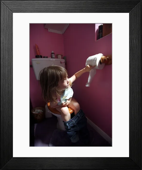 Framed Print : A child learning to use the toilet Framed Print : A child learning to use the toilet