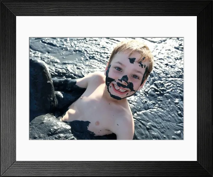 Framed Print : Kid lying in healing mud, Primorsko-Akhtarsk, Russia Framed Print : Kid lying in healing mud, Primorsko-Akhtarsk, Russia