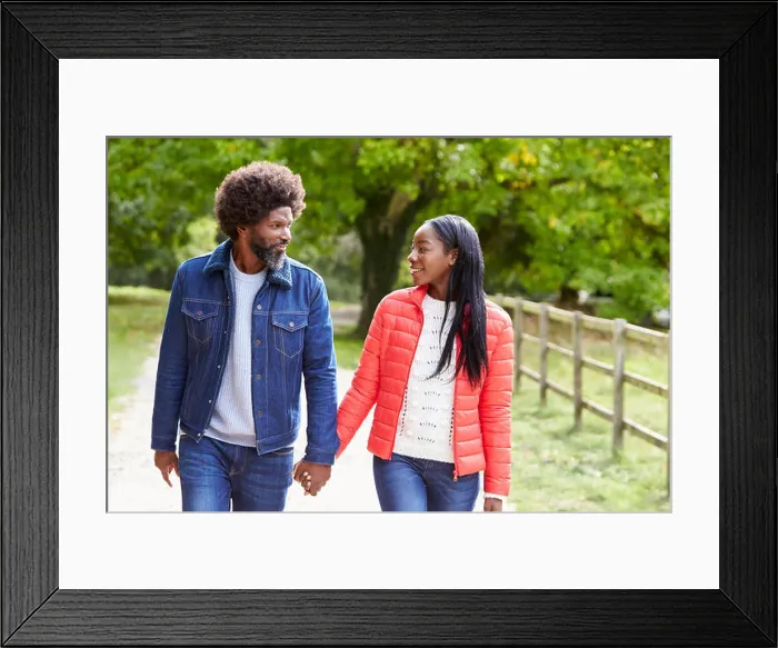 Framed Print : Black adult couple, boyfriend, girlfriend walk holding hands in the countryside, close up