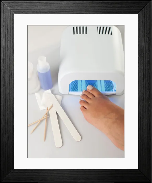 Framed Print : Feet with uv lamp for nails Framed Print : Feet with uv lamp for nails