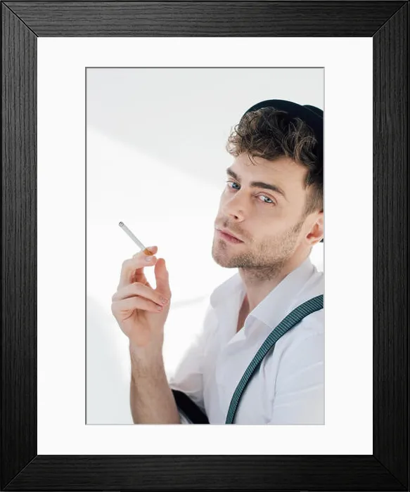 Framed Print : handsome man holding cigarette and looking at camera Framed Print : handsome man holding cigarette and looking at camera