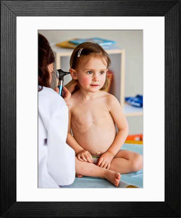 Framed Print : Doctor examining the ears of a 3-year-old girl with an otoscope Framed Print : Doctor examining the ears of a 3-year-old girl with an otoscope