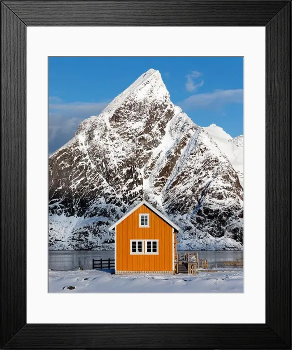 Framed Print : A traditional yellow Rorbu cabin with Mount Olstinden peak set as a dramatic background in the village of Sakrisoya Framed Print : A traditional yellow Rorbu cabin with Mount Olstinden peak set as a dramatic background in the village of Sakrisoya