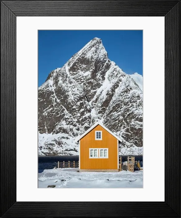 Framed Print : traditional norwegian wooden house rorbu to stand on the shore of the fjord and mountains in the distance Framed Print : traditional norwegian wooden house rorbu to stand on the shore of the fjord and mountains in the distance