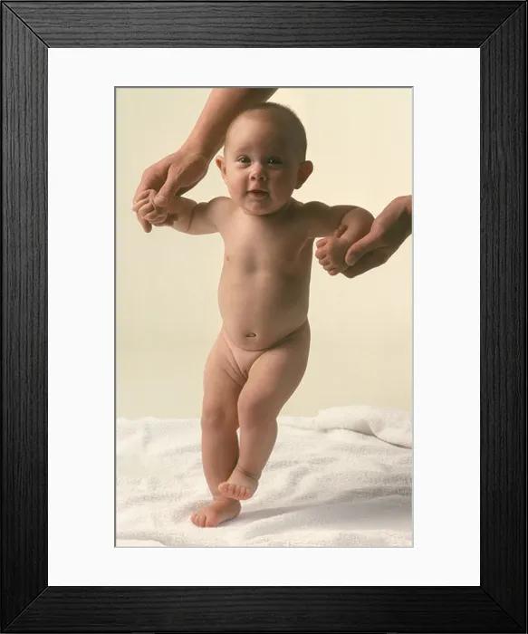 Framed Print : baby standing up with help of fathers support Framed Print : baby standing up with help of fathers support