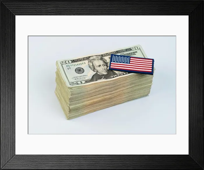 Framed Print : American flag on pile of 20 dollar banknote isolated on white studio background Framed Print : American flag on pile of 20 dollar banknote isolated on white studio background