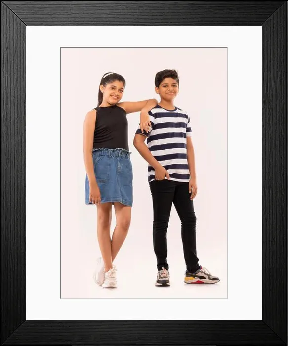 Framed Print : Cheerful boy and girl standing together against white background Framed Print : Cheerful boy and girl standing together against white background