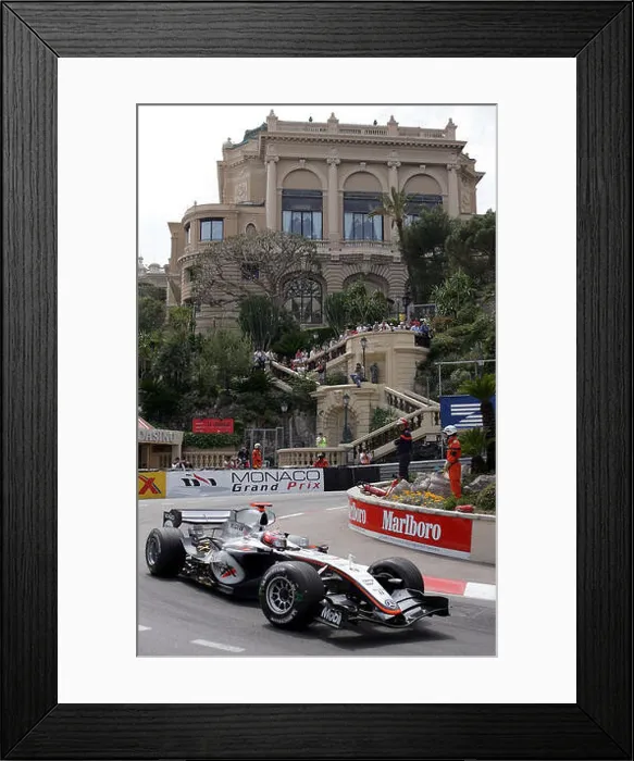 Framed Print : (dpa) - Finnish Formula One driver Kimi Raikkonen of McLaren Mercedes leads the Monaco Grand Prix in Monte Carlo