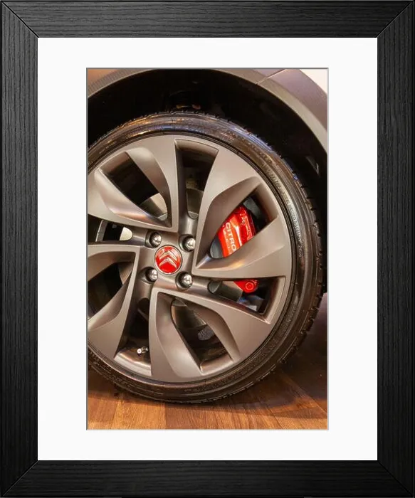 Framed Print : The metallic grey alloy wheel of a Citroen car with a bright red Citroen badge and brake caliper Framed Print : The metallic grey alloy wheel of a Citroen car with a bright red Citroen badge and brake caliper