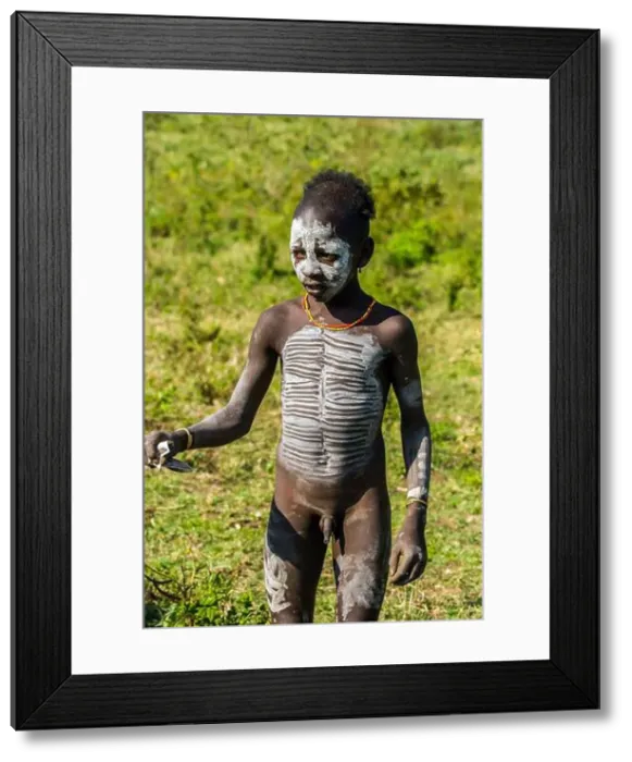 Framed Print : Portrait of young Hamer tribe boy with necklaces and impressive body painting, Omo Valley, Southern Ethiopia Framed Print : Portrait of young Hamer tribe boy with necklaces and impressive body painting, Omo Valley, Southern Ethiopia