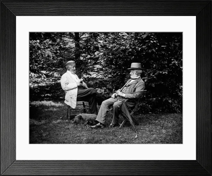 Framed Print : TURN OF THE CENTURY TWO MEN SITTING OUTSIDE IN CHAIRS AMONG TREES SMOKING CIGARS TALKING DOG LAYING AT THEIR FEET Framed Print : TURN OF THE CENTURY TWO MEN SITTING OUTSIDE IN CHAIRS AMONG TREES SMOKING CIGARS TALKING DOG LAYING AT THEIR FEET