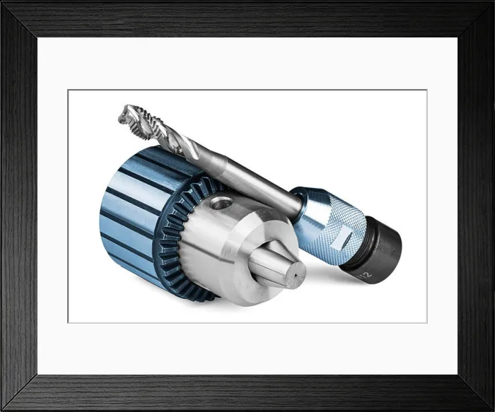 Framed Print : Spiral flute tap and chuck with jaws on white background Framed Print : Spiral flute tap and chuck with jaws on white background